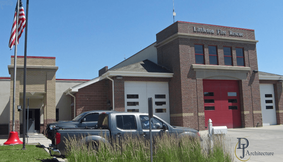 Littleton Fire Rescue station: a red brick fire station with its flag flying and apparatus bays at the front
