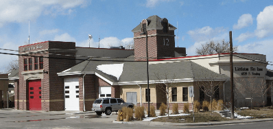 Littleton Fire Rescue station with a red brick tower numbered 12 and red and white bay doors