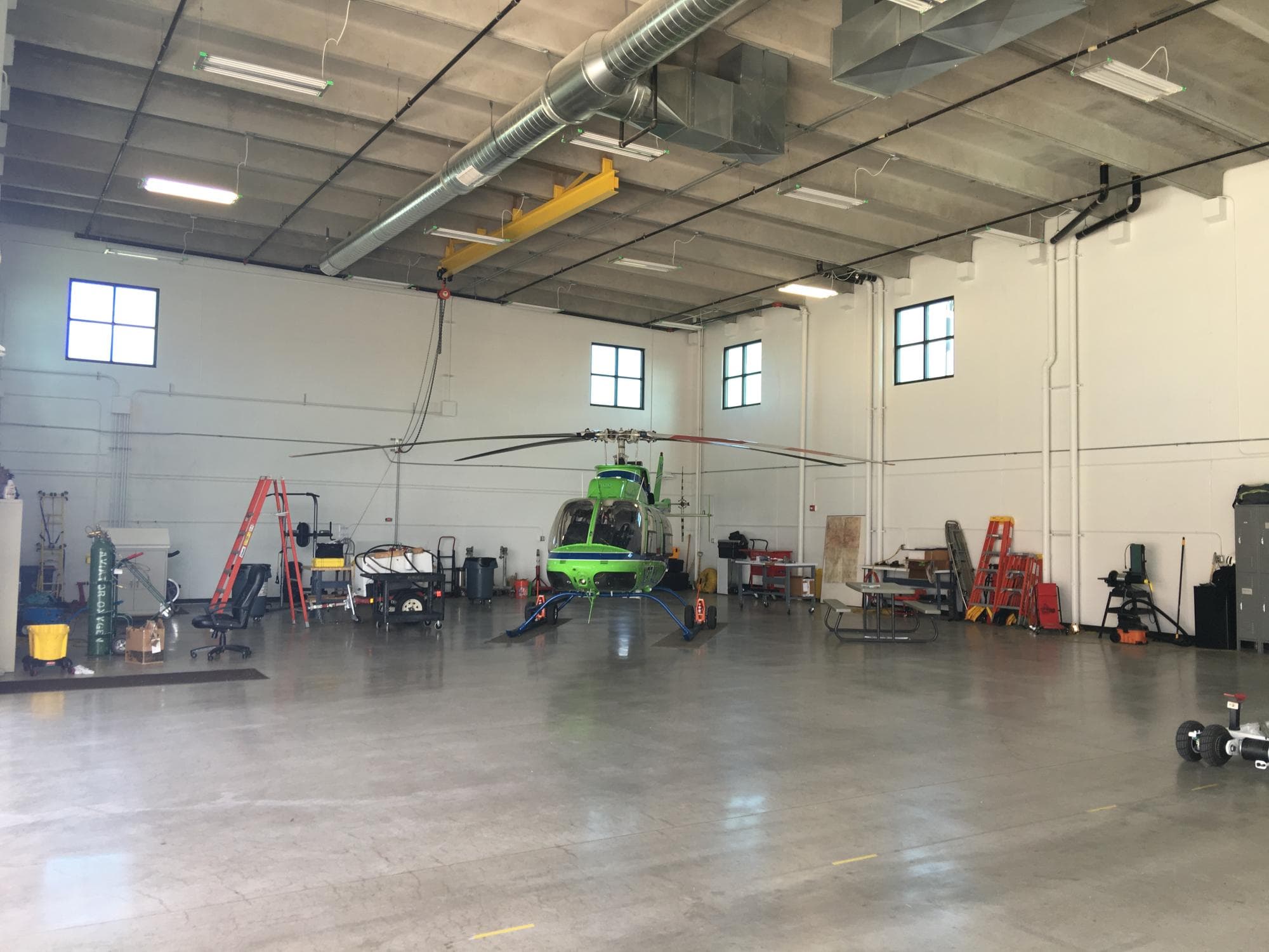 Inside the Air Life hangar bay, with a helicopter parked under the lights